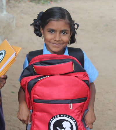 Ready-to-Learn Happy girl posing with her new backpack filled with school supplies, ready to learn.